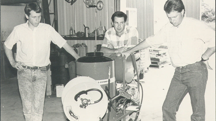 ELEY founders with early pressure washer hose reel system, black-and-white photo from 1992
