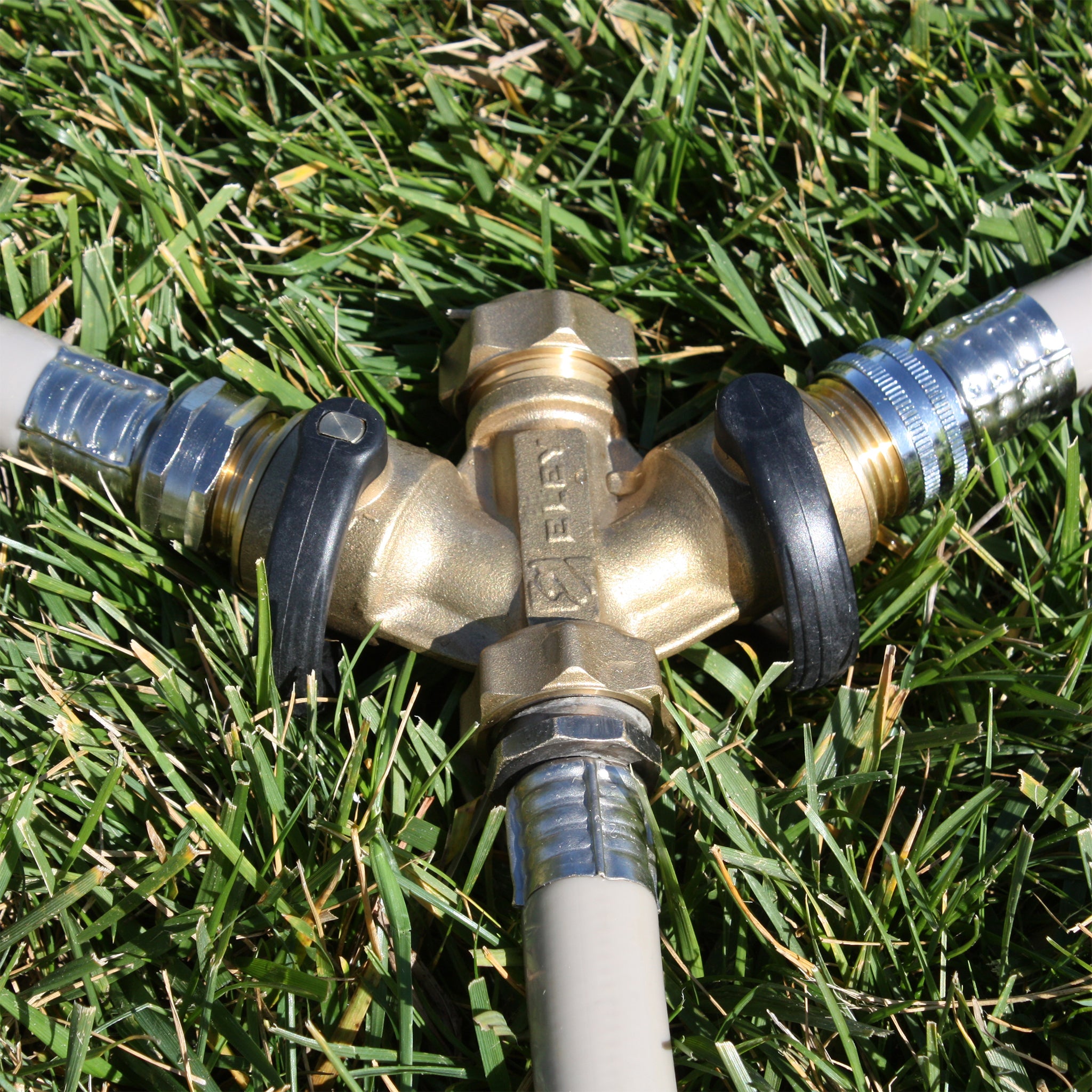 Eley 3/4-inch brass garden hose cap on garden hose 2-way Y-valve in grass