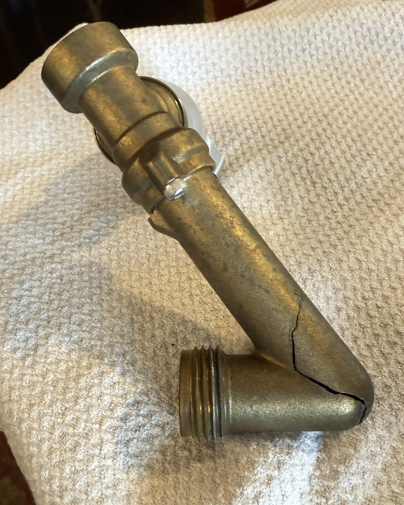 Cracked Brass Housing on the 4291 swivel laying on white cloth surface