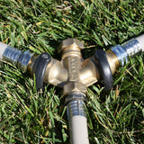 Eley 3/4-inch brass garden hose cap on garden hose 2-way Y-valve in grass 